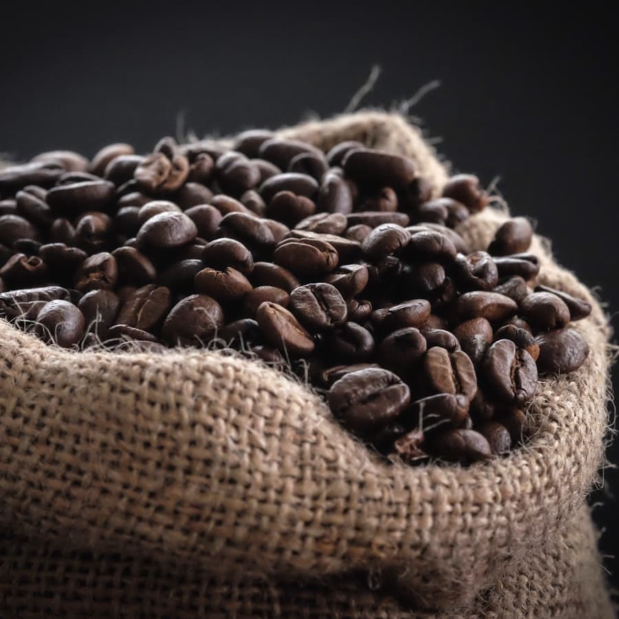 Roasted coffee beans spilling from a hessian sack