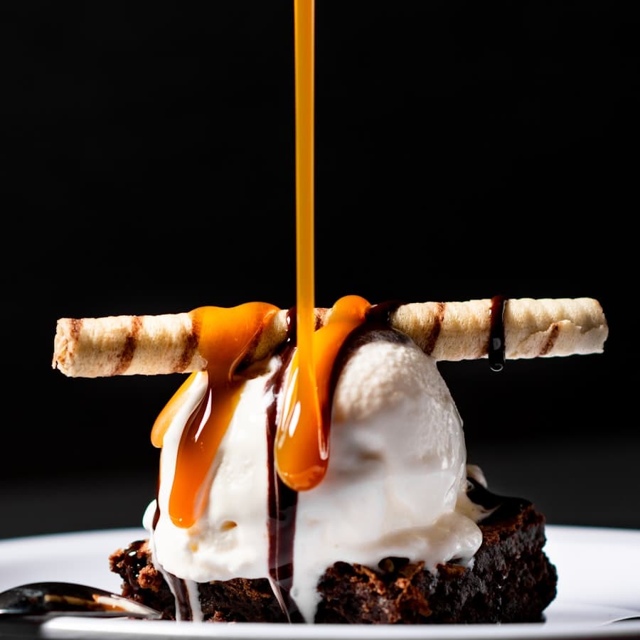 Caramel poured over a brownie sundae
