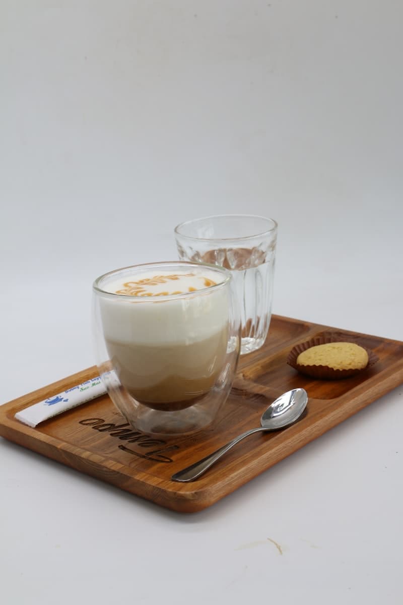 A caramel latte with layered milk and espresso